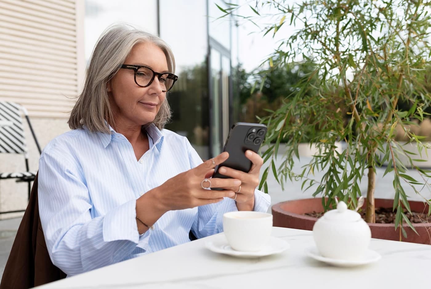 Mature woman enjoying a cup of tea and an online conversation